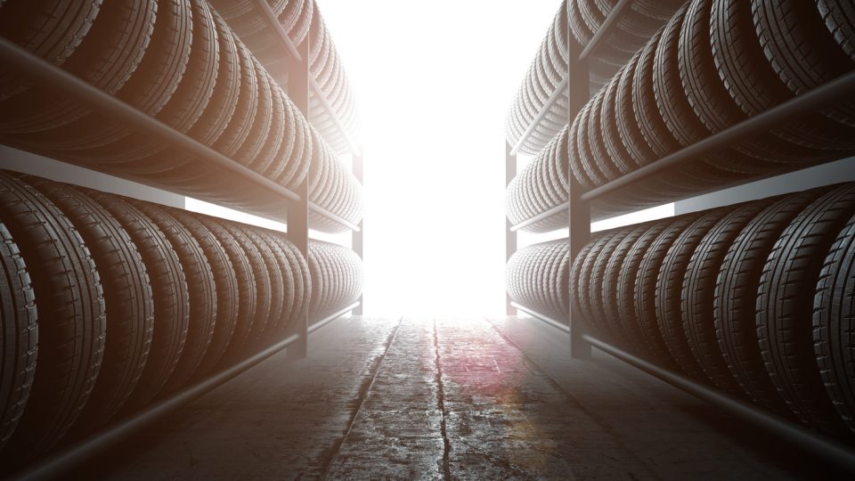 3D illustration, car tires rack in workshop background, back lit