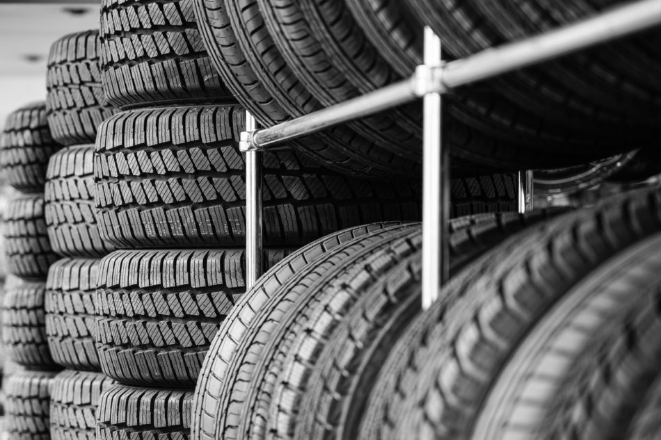 Rack with variety of new car tires in automobile store