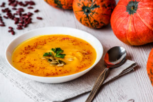 Pumpkin soup with seeds and parsley.