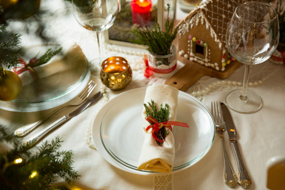 Beautiful served table with Christmas decorations, candles and lanterns