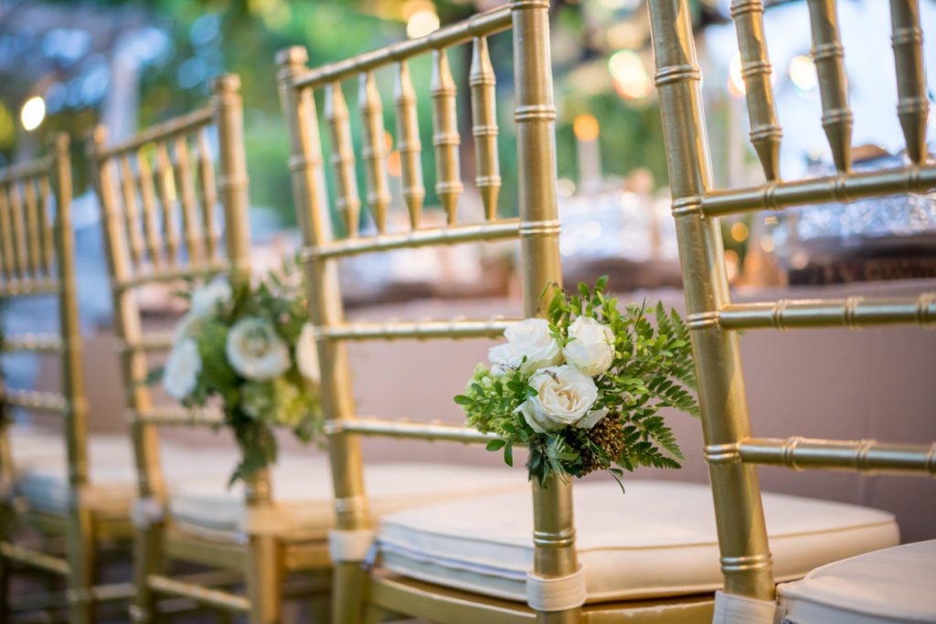 Flower decoration on chairs for garden wedding reception